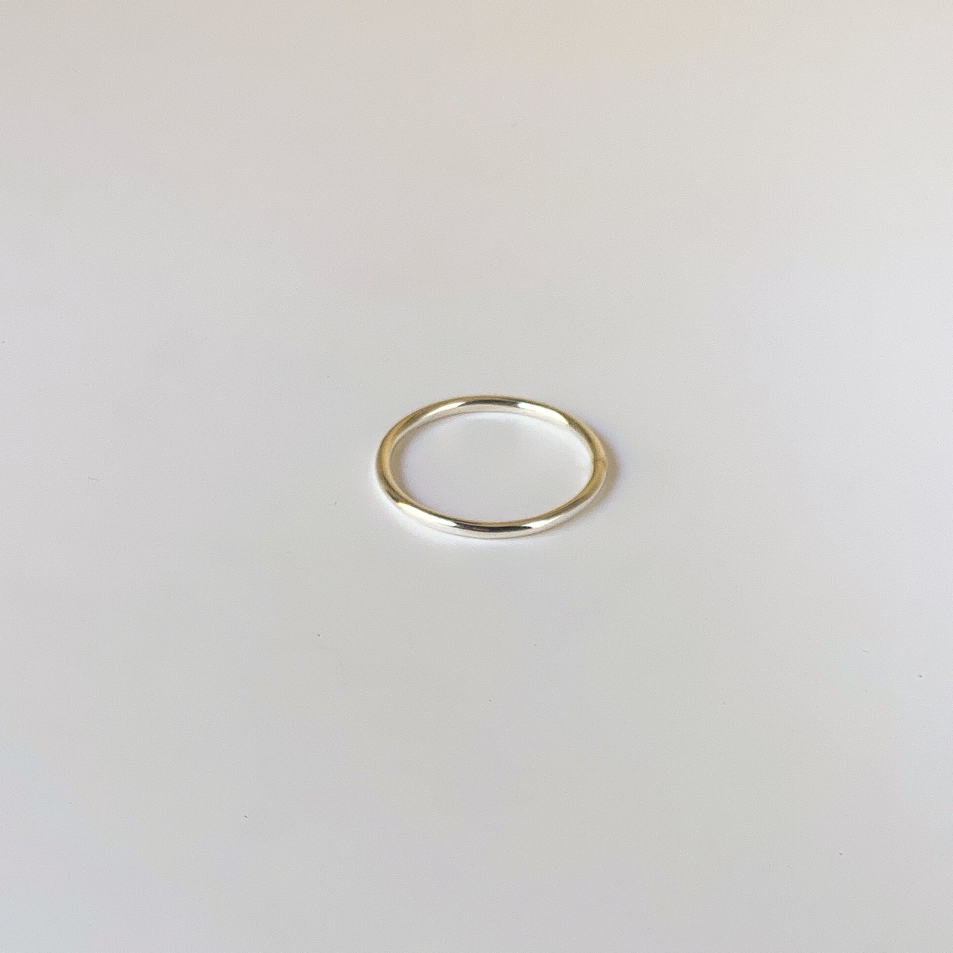 Gold ring on a light gray background