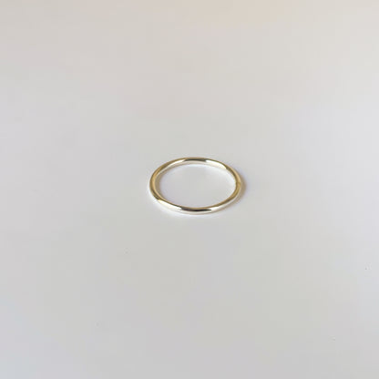 Gold ring on a light gray background