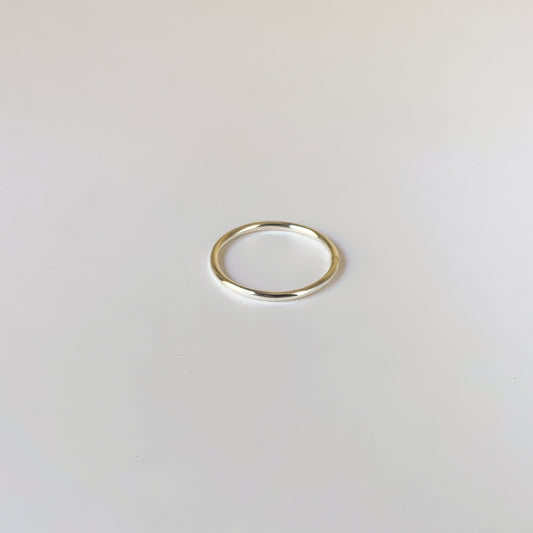 Gold ring on a light gray background