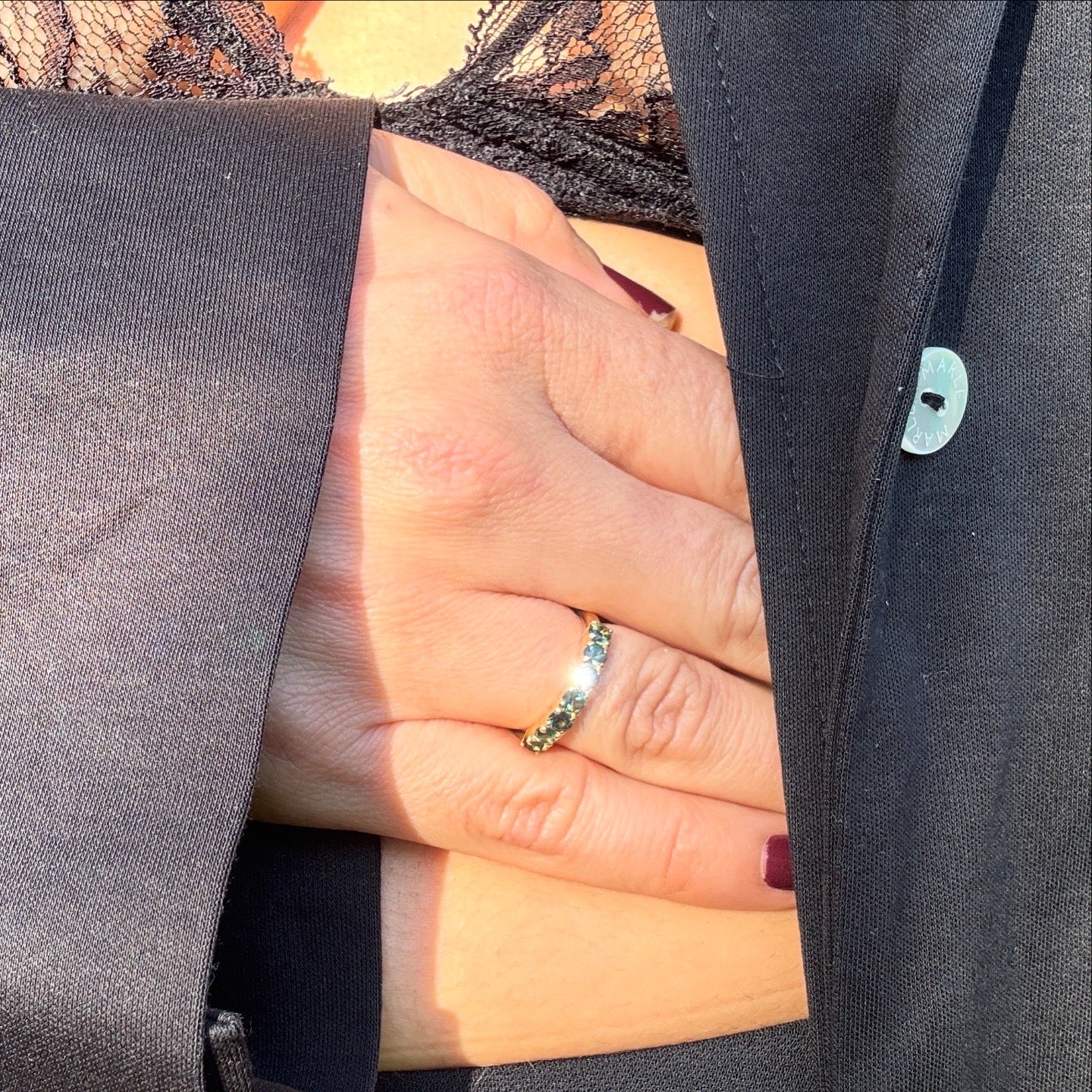 Close-up of a hand wearing a ring with a blurred background