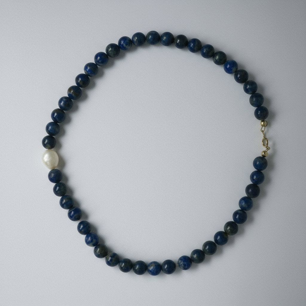 Necklace with blue beads on a white background