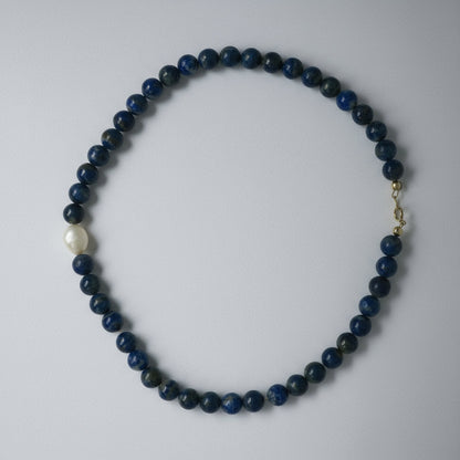 Necklace with blue beads on a white background