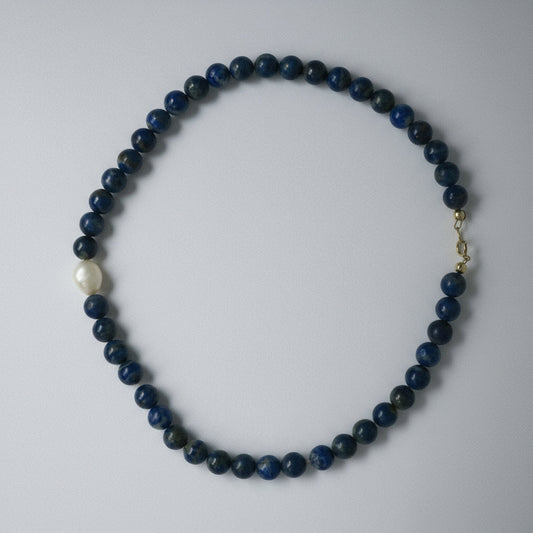 Necklace with blue beads on a white background