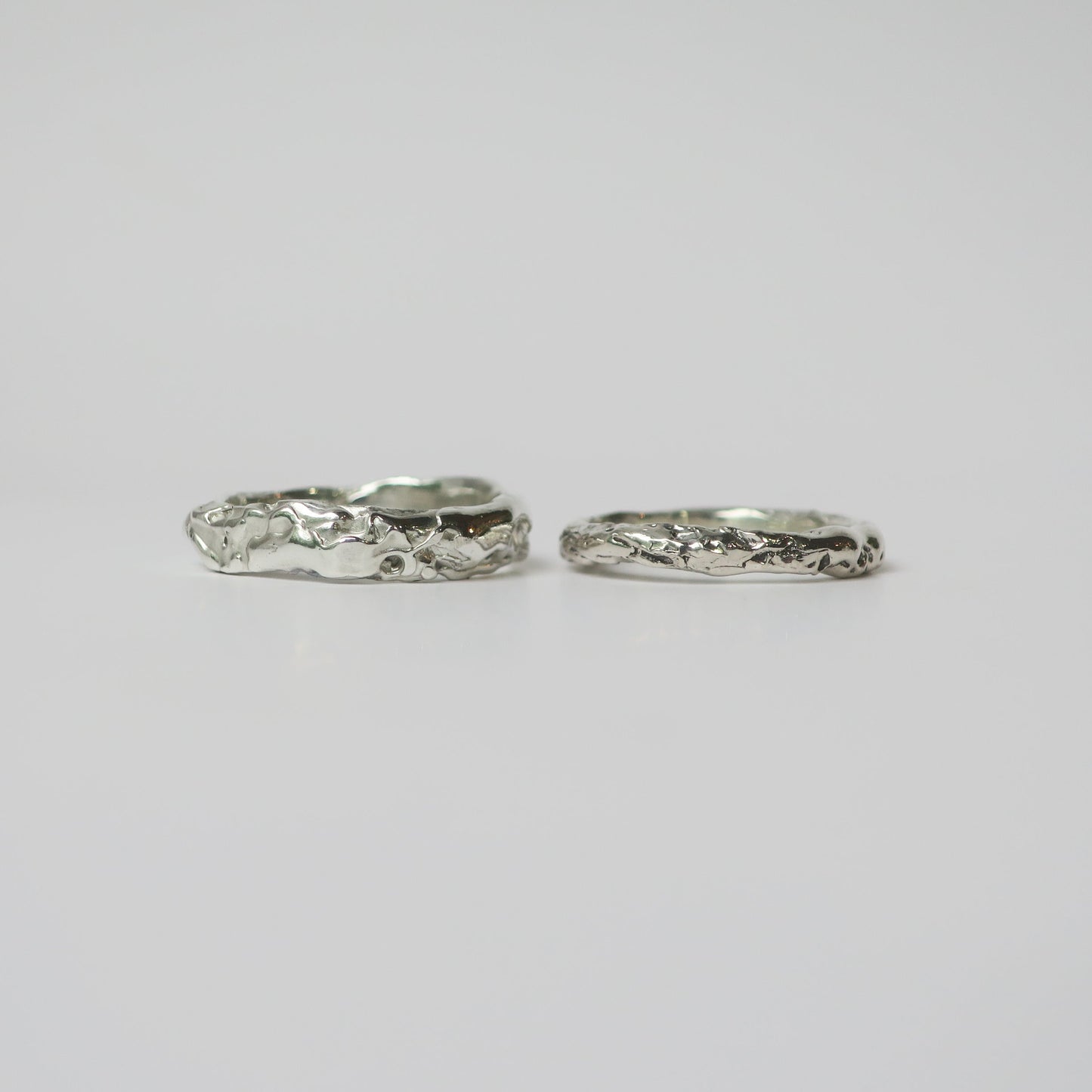 Two silver rings on a light gray background
