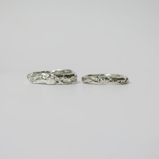 Two silver rings on a light gray background