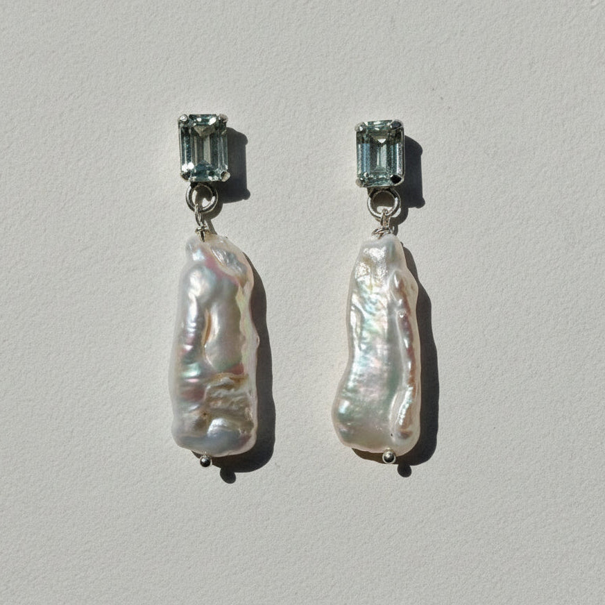 Pair of earrings on a light gray background