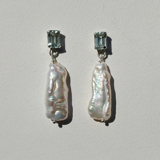 Pair of earrings on a light gray background