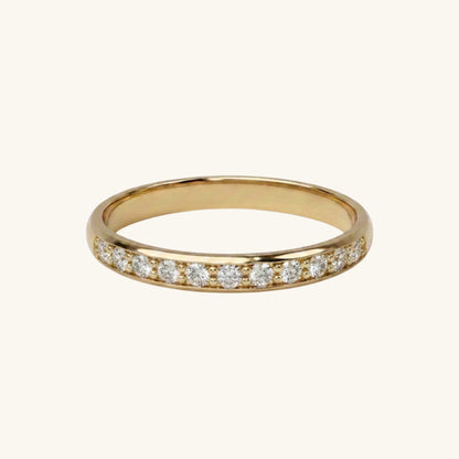 Gold ring with small diamonds on a white background