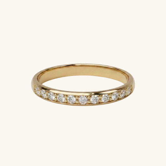 Gold ring with small diamonds on a white background