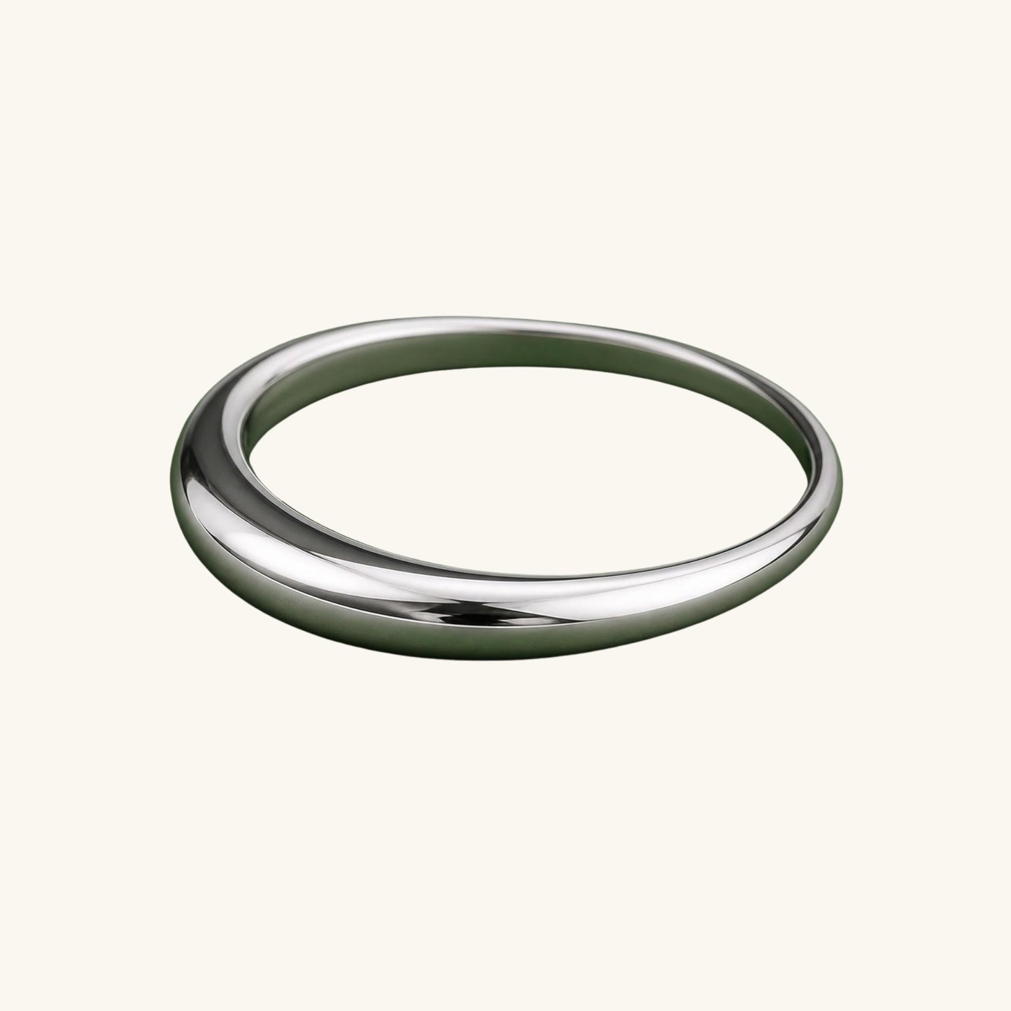 Silver ring on a cream background