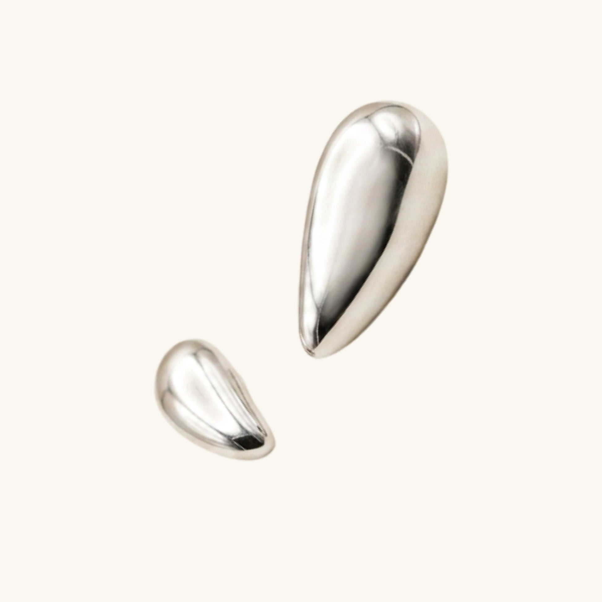 Two silver teardrop-shaped earrings on a white background