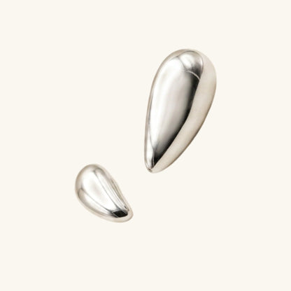Two silver teardrop-shaped earrings on a white background