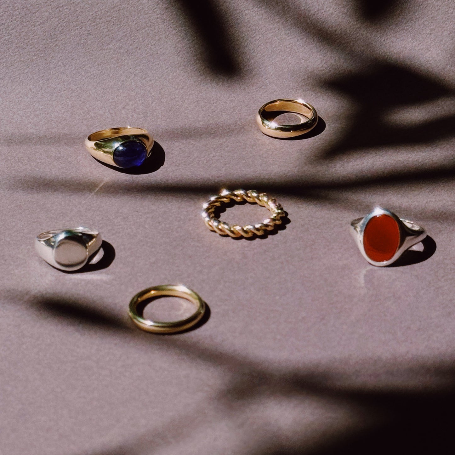 selection of rings in silver and gold on a dark and shadowy background