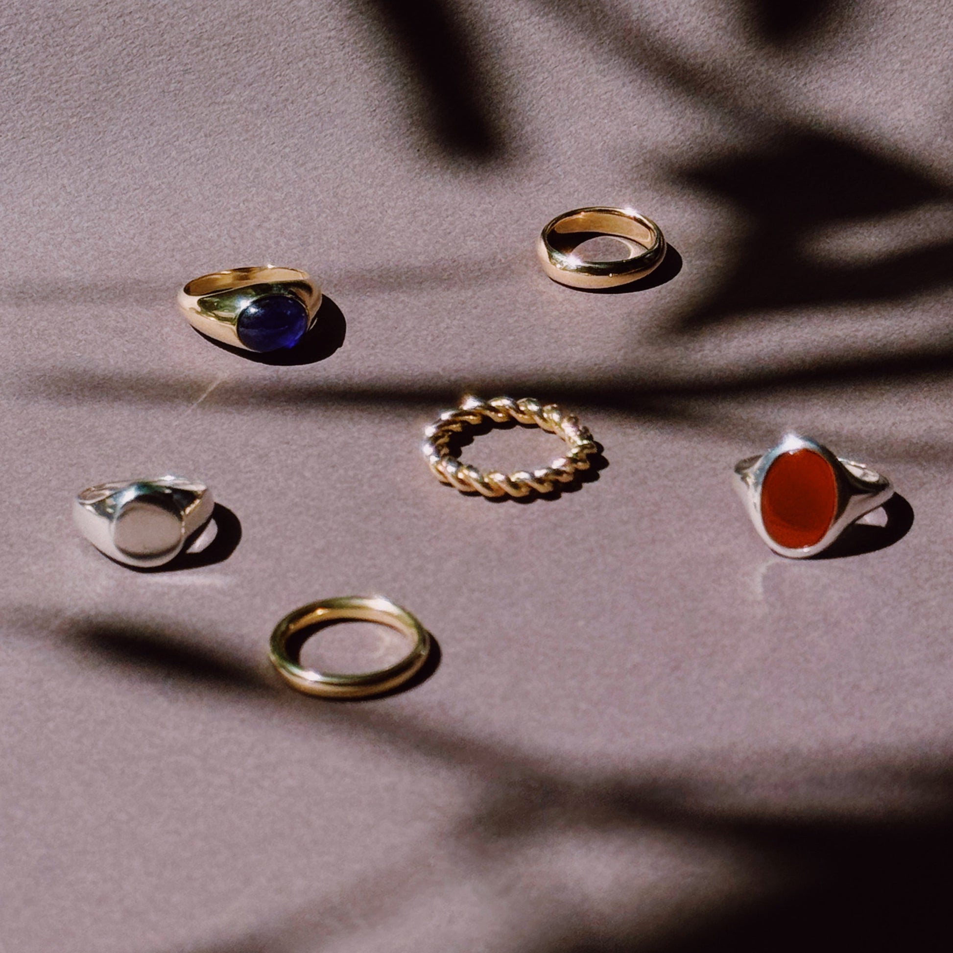 selection of rings in silver and gold on a dark and shadowy background
