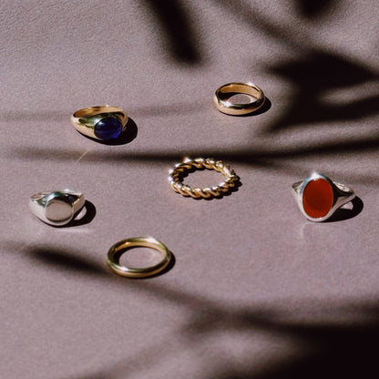 selection of rings in silver and gold on a dark and shadowy background