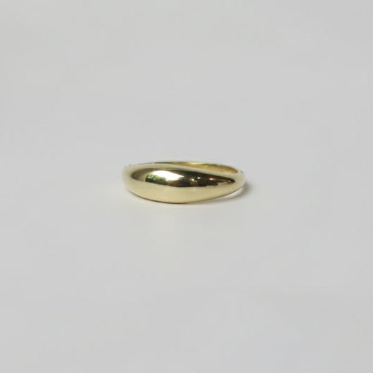 Gold ring on a light gray background