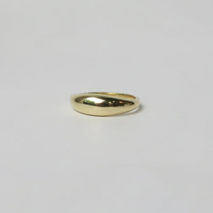 Gold ring on a light gray background