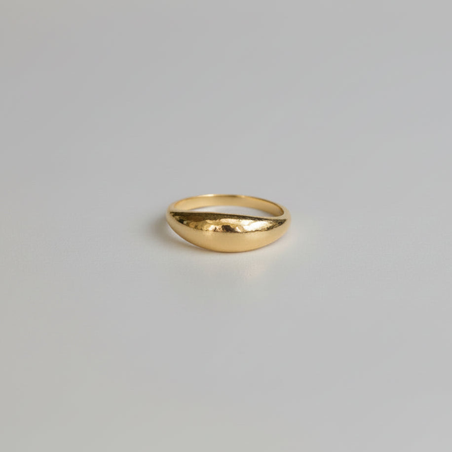 Gold ring on a light gray background