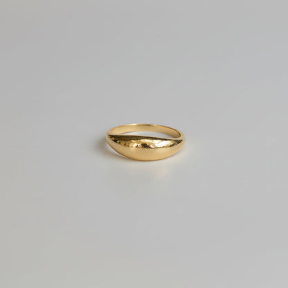 Gold ring on a light gray background