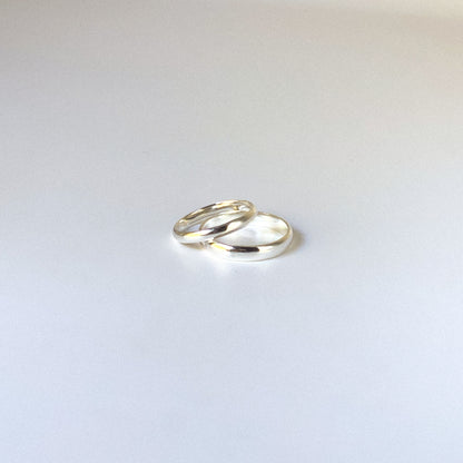 Two silver rings on a light gray background