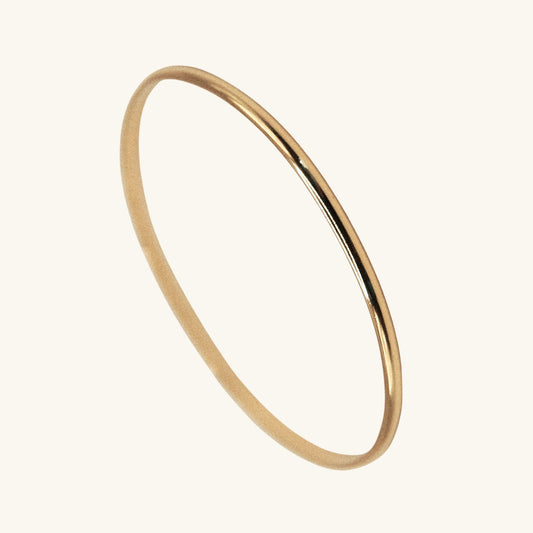 Gold bangle on a white background