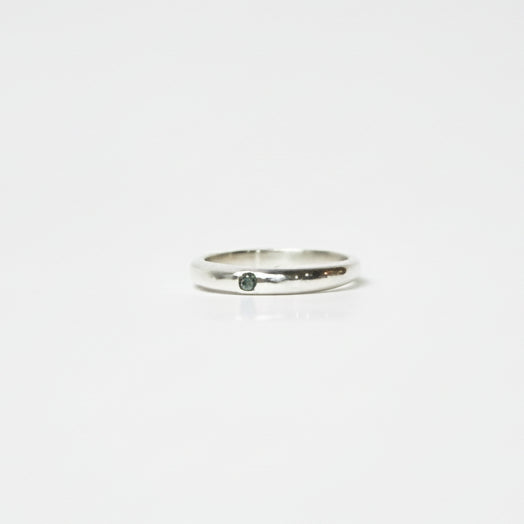 Silver ring on a light gray background