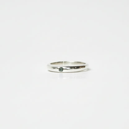 Silver ring on a light gray background