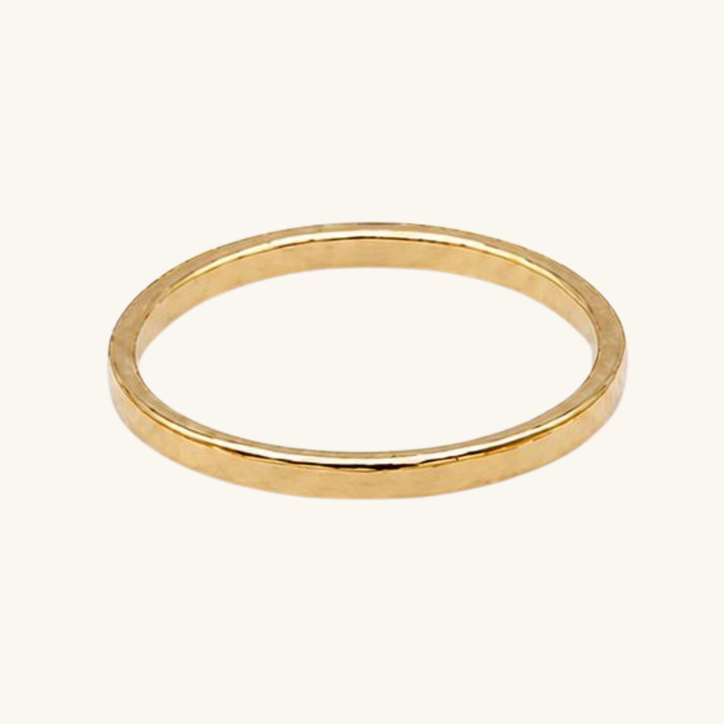 Gold textured ring on a white background
