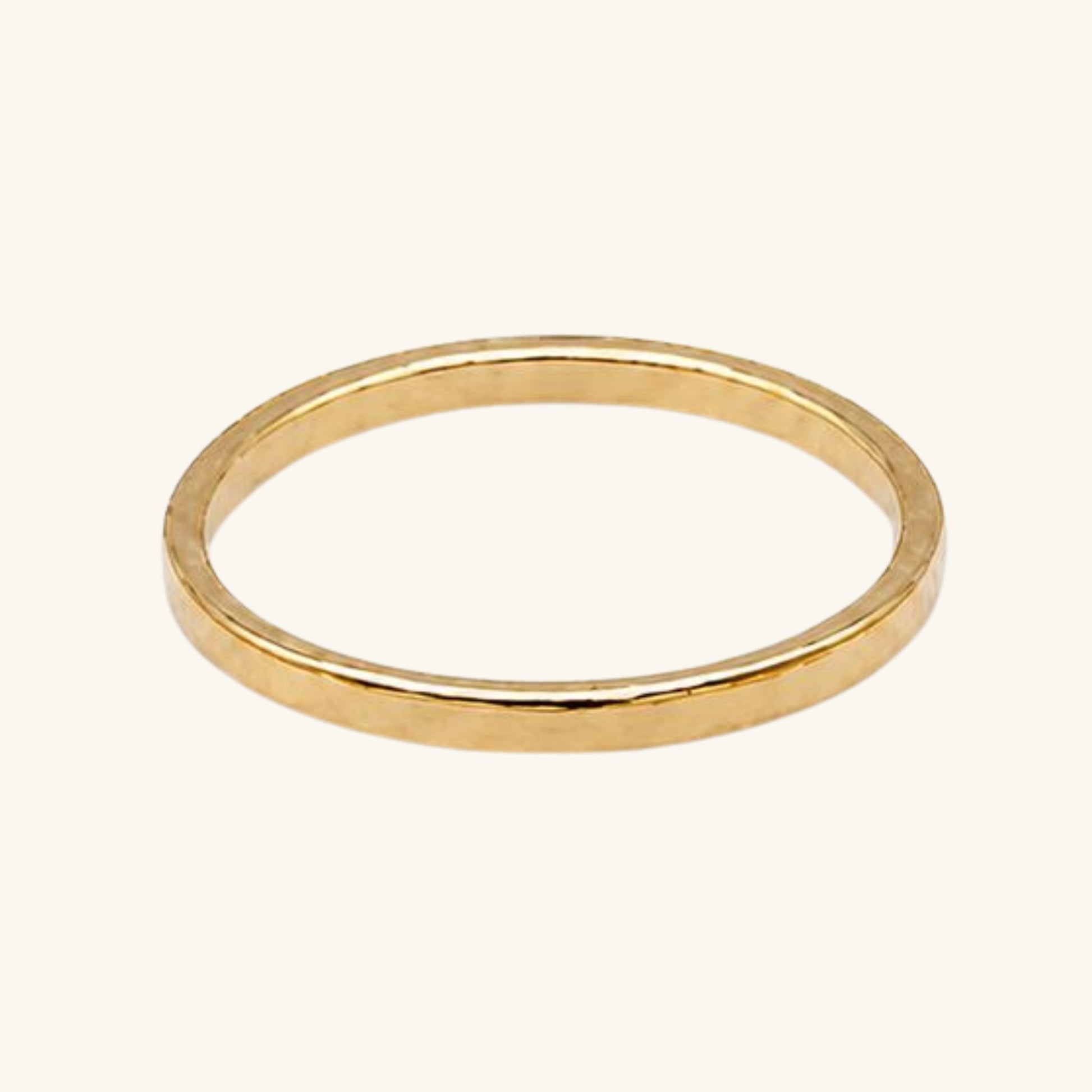 Gold textured ring on a white background