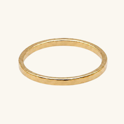 Gold textured ring on a white background