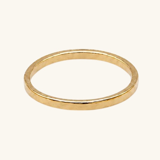 Gold textured ring on a white background