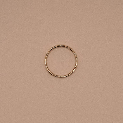 Gold ring on a beige background