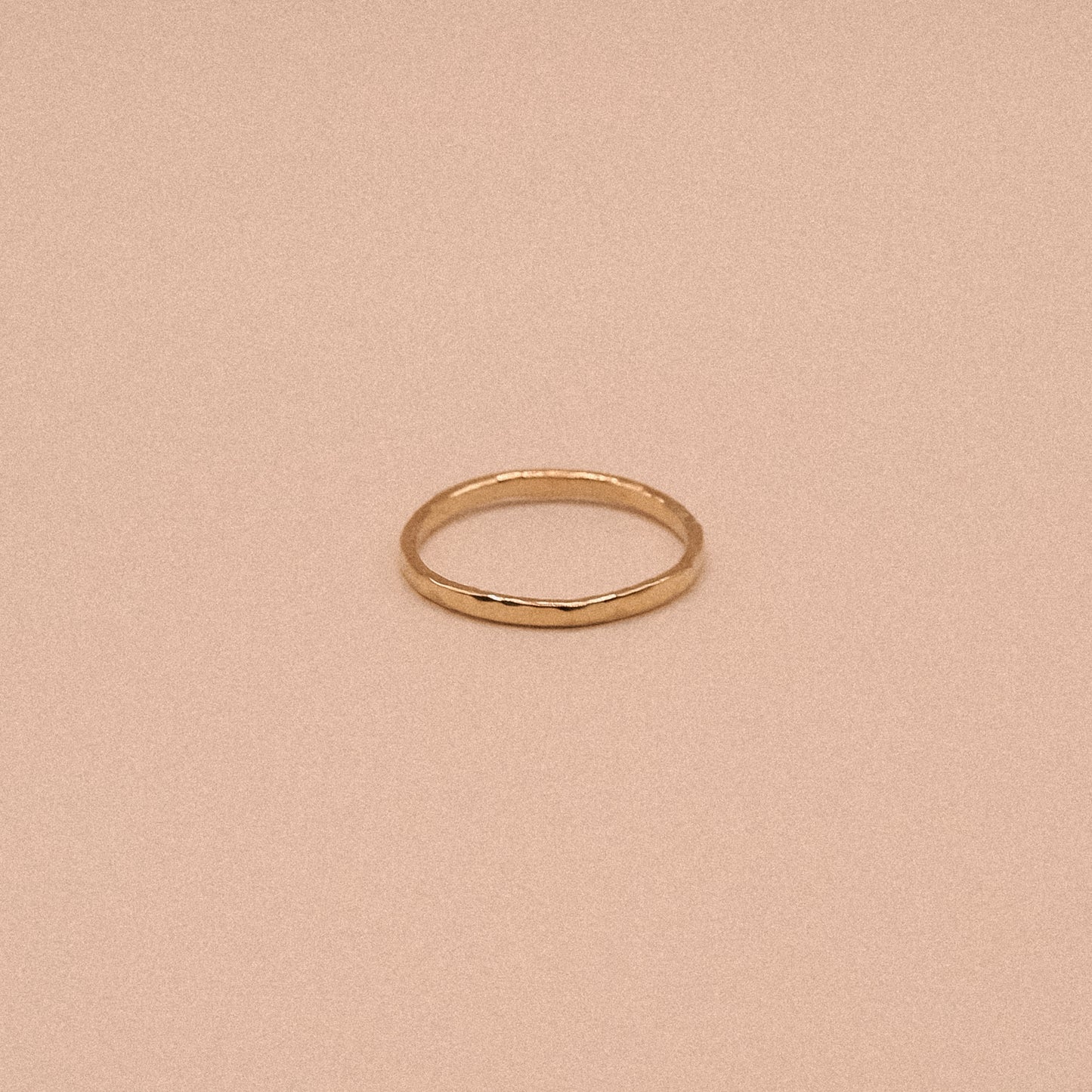 Gold ring on a beige background