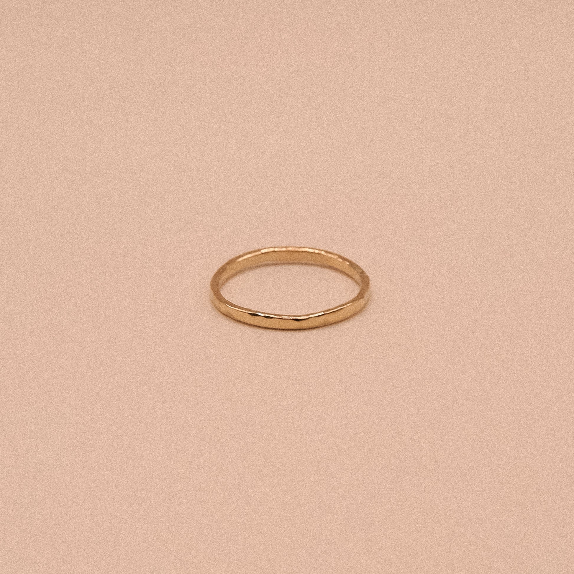 Gold ring on a beige background