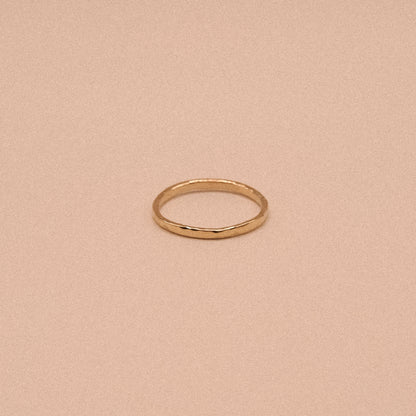 Gold ring on a beige background