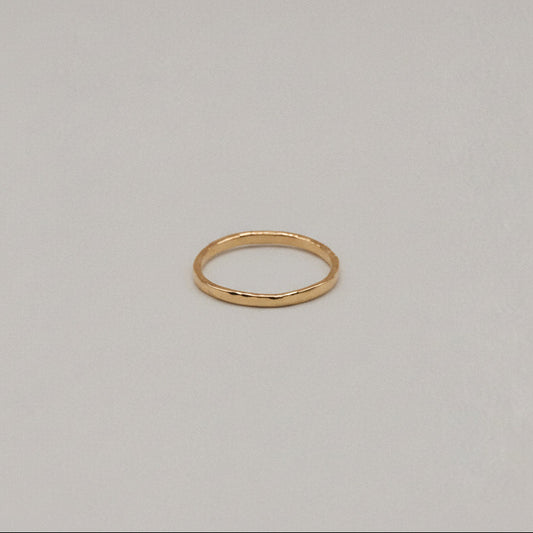Gold ring on a beige background
