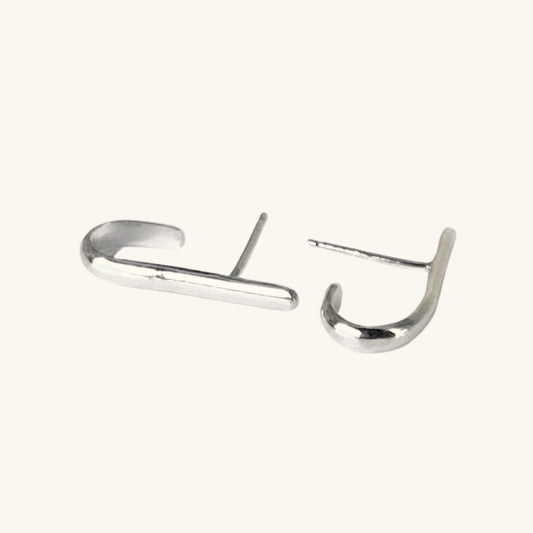 Pair of silver hoop earrings on a white background