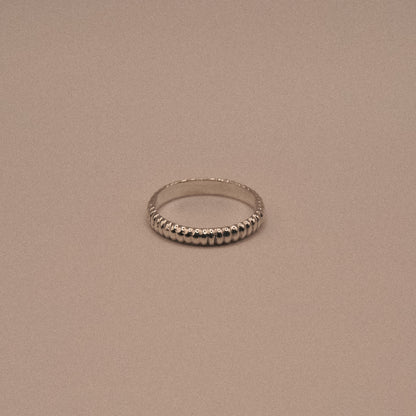 Silver ring on a beige background