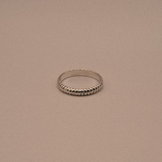 Silver ring on a beige background