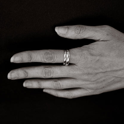 Hand with two rings on a black background