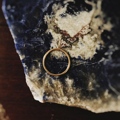 gold ring on a terxtured rock background